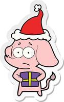 sticker cartoon of a unsure elephant with christmas present wearing santa hat vector