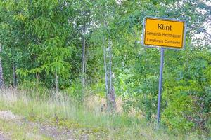 Natural panorama yellow road sign green plants trees forest Germany. photo