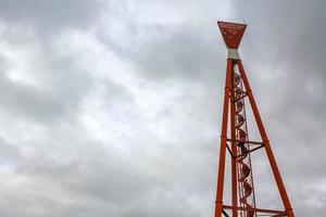 Industrial area cranes red tower lighthouse dyke seascape panorama Germany. photo