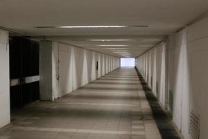 A narrow and long corridor on the lower floor of the building. photo