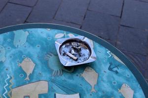 Ashtray - a place for tobacco ash and cigarette butts photo