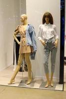 A mannequin stands on a showcase in a store. photo