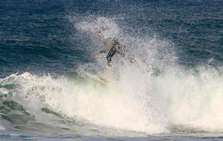 December 21, 2018 Israel. Surfing on high waves in the Mediterranean. photo