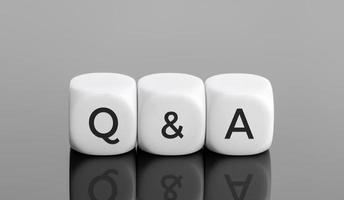 Q and A or questions and answers concept. White blocks shape with text on desk. Copy space photo