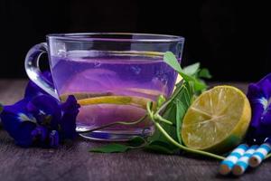 Butterfly pea and lemon juice, healthy drinks. Dark tones photo