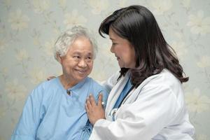 Doctor using stethoscope to checking the patient sit down on a bed in the hospital ward, healthy strong medical concept photo