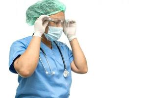 Asian doctor wearing face shield and PPE suit to check patient protect safety infection Covid 19 Coronavirus outbreak at hospital with copy space. photo