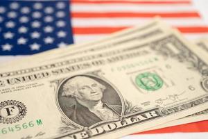 US dollar banknotes money on USA America flag, finance banking concept. photo