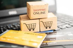 Shopping online box with credit card on laptop computer. Finance commerce import export business concept. photo