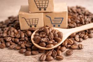 Box with shopping cart logo symbol on coffee beans, Import Export Shopping online or eCommerce delivery service store product shipping, trade, supplier concept. photo