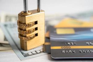 Credit card with password key lock security on US dollar background. photo