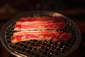 Grilling wagyu beef on charcoal grill photo