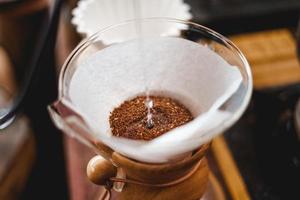 Closeup of hands barista make coffee photo