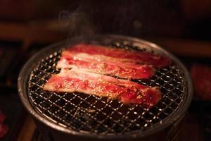 Grilling wagyu beef on charcoal grill photo