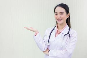 Asian woman doctor shows her hand to present photo