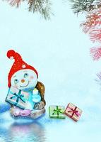 Happy snowman on a winter landscape background. photo