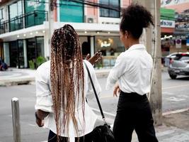 Backside female and male diversity african afro hair walking talk friendship university education multiracial group colleague partner street lifestyle freedom relax enjoy fun outdoor travel photo