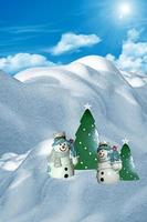 Christmas card. Snowmen in the winter forest photo