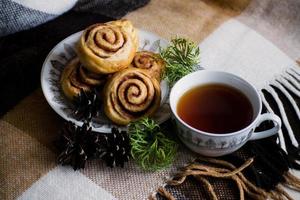 Cinnamon rolls buns with spices and tea. Kanelbulle - swedish sweet homemade dessert. Christmas baking pastry. photo