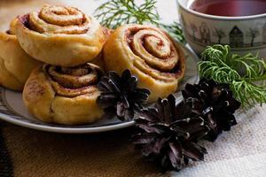 Cinnamon rolls buns with spices and tea. Kanelbulle - swedish sweet homemade dessert. Christmas baking pastry. photo