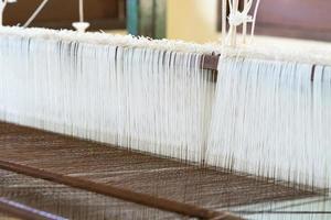 Weave silk cotton on the manual wood loom photo