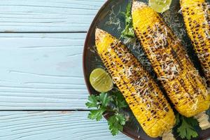 barbecue and grilled corn with cheese and lime photo