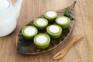 Kue Nona Manis, traditional Indonesian cake made from wheat flour, rice flour, sugar, salt, coconut milk, and pandan leaves, then steamed. Selected focus. photo