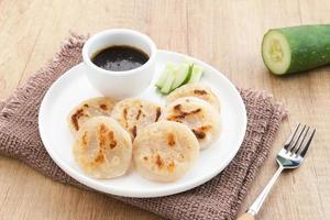 Pempek Panggang or Pempek Tunu, traditional food from South Sumatra, Indonesia. This fish-based food is very popular. Served with cuko sauce. photo