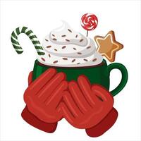 Red-gloved hands hold a green cup filled with hot cocoa, whipped cream and candy. Christmas drinks.