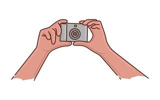 a pair of hands holding a pocket camera vector