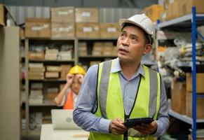 Warehouse Manager, Thinking and reviewing the preparation of products that must be distributed to retailers during the price increase in the market. photo