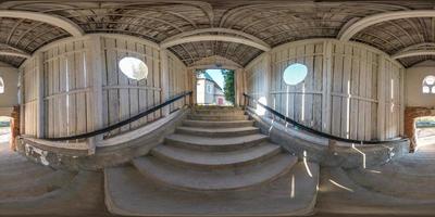 full seamless spherical panorama 360 degrees angle view  in wooden tunnel with concrete staircase  in equirectangular projection, ready VR AR virtual reality content photo