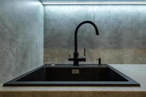 water tap sink with faucet in expensive kitchen photo