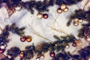 New Year's toys and fir branches on a marble background photo