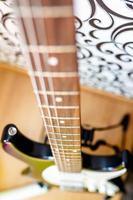 electro guitar neck standing on the blurred floor photo