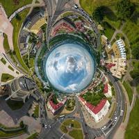 blue sphere inside overlooking old town, urban development, historic buildings, crossroads with bridge across wide river. Transformation of spherical 360 panorama in abstract aerial view. photo