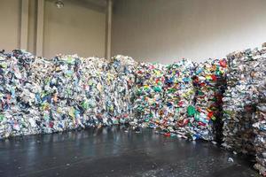 Plastic pressed bales at the modern waste hazardous processing plant. Separate garbage collection. Recycling and storage of waste for further disposal. Business for sorting and processing of waste. photo