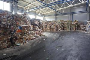 Plastic bales of rubbish at the waste treatment processing plant. Recycling separatee and storage of garbage for further disposal, trash sorting. Business for sorting and processing of waste. photo