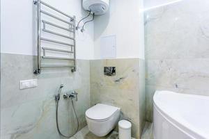 toilet and detail of a corner shower bidet with soap and shampoo dispensers on wall mount shower attachment photo