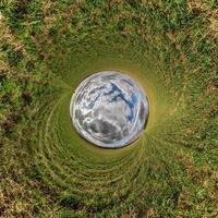 blue sphere little planet inside green grass round frame background. photo