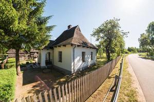 authentic vintage stone village house near the road photo