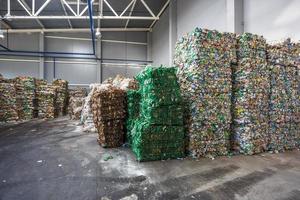 Plastic bales of rubbish at the waste treatment processing plant. Recycling separatee and storage of garbage for further disposal, trash sorting. Business for sorting and processing of waste. photo