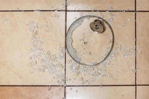 Broken glass lid on the ceramic tiles floor. Family quarrel. Irritation. broken dishes for happiness photo