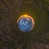 Inversion of little planet transformation of spherical panorama 360 degrees. Spherical abstract aerial view in field with awesome beautiful clouds. Curvature of space. photo