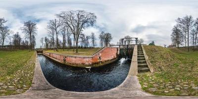 panorama 360 angle view near gateway lock construction on river, canal for passing vessels at different water levels. Full spherical 360 degrees seamless panorama in equirectangular projection photo