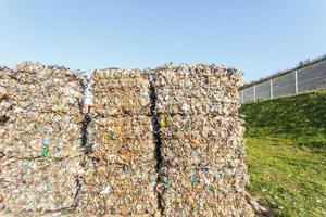 Plastic bales of rubbish at the waste treatment processing plant. Recycling separatee and storage of garbage for further disposal, trash sorting. Business for sorting and processing of waste. photo