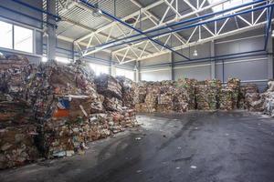 Plastic bales of rubbish at the waste treatment processing plant. Recycling separatee and storage of garbage for further disposal, trash sorting. Business for sorting and processing of waste. photo