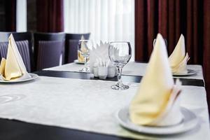 Closeup of empty wine glasses on banquet table in restaurant photo