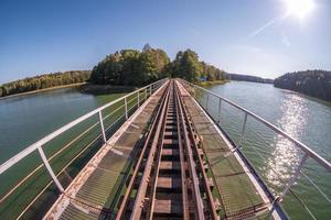 iron steel frame construction of narrow gauge railway bridge across the river photo