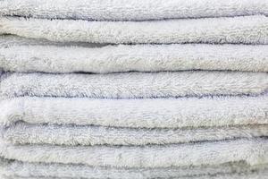 Stack of pastel white plush bath hotel towels. photo